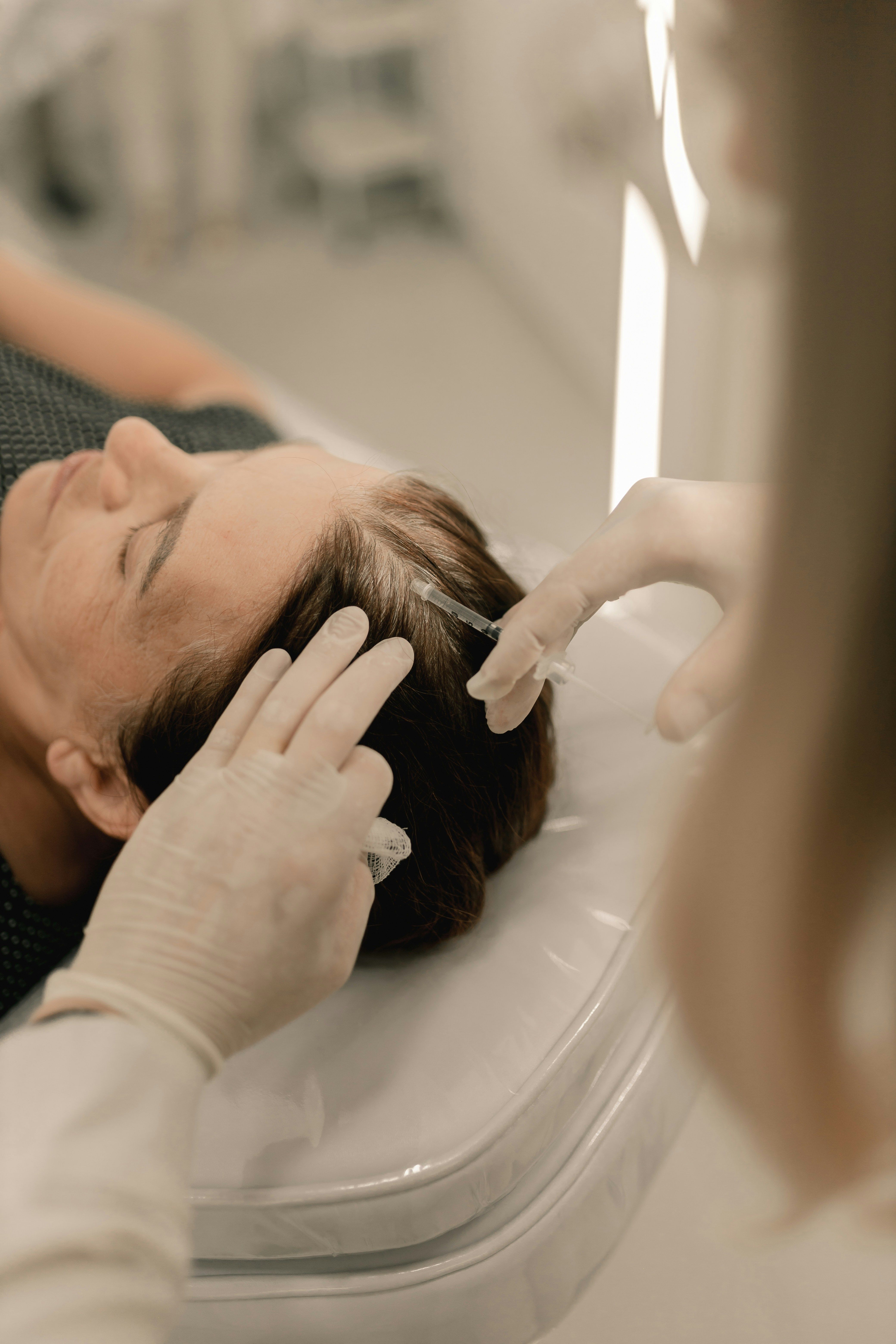 A scalp regenerative therapy session in progress.